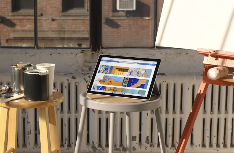 women working on table with laptop